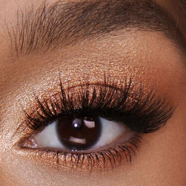 Uma das maneiras mais fáceis de fazer a transição da maquiagem diurna para um visual noturno é intensificar a maquiagem dos olhos. Um truque simples é aplicar um tom de sombra mais escuro no vinco e no canto externo, criando profundidade e dimensão. Adicionar um toque de brilho ou purpurina no centro da pálpebra pode fazer com que seus olhos se destaquem instantaneamente e dar a eles uma aparência glamourosa, pronta para a noite.